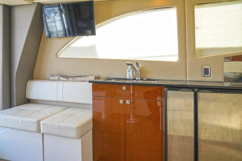 Slide: The Image of Interior of 2020 Carver C40 yacht with kitchenette, seating, and TV. - 13