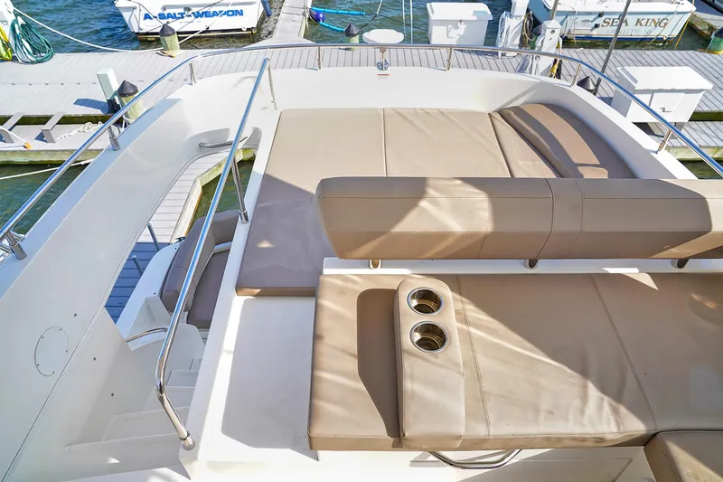 Slide: The Image of Luxurious seating area on 2020 Carver C40 yacht with cup holders, docked at marina. - 3