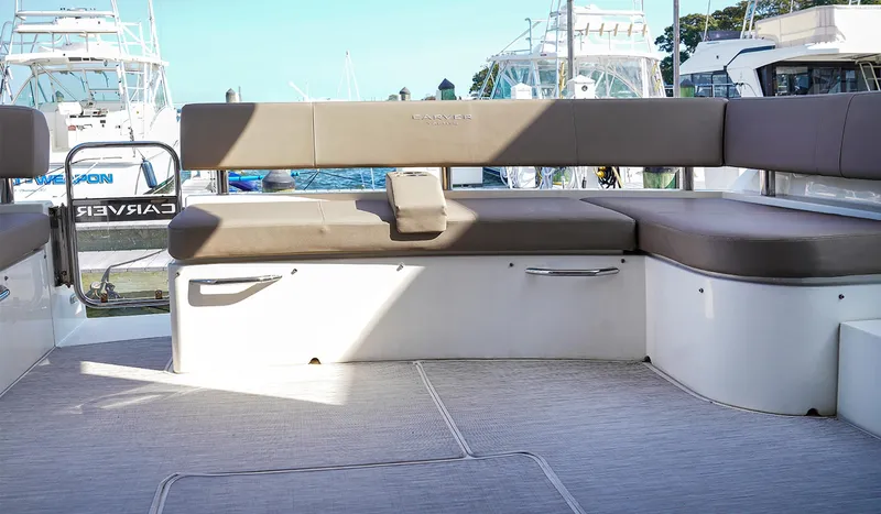 Slide: The Image of 2020 Carver C40 yacht deck with cushioned seating, docked at marina. - 6