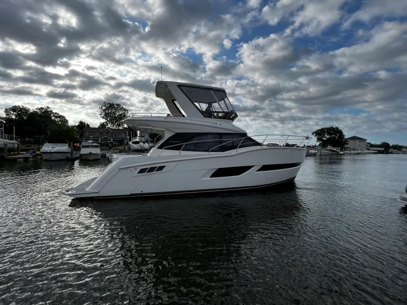 The Image of 2020 Carver C40 yacht on a calm waterway under a partly cloudy sky. - 0