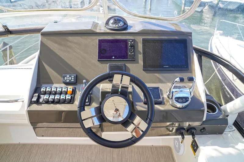Slide: The Image of Helm of 2020 Carver C40 yacht with modern navigation controls and steering wheel. - 12