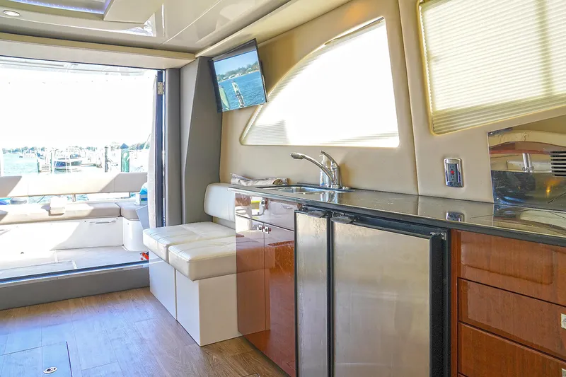 Slide: The Image of Interior of 2020 Carver C40 yacht with modern kitchen and seating area. - 14