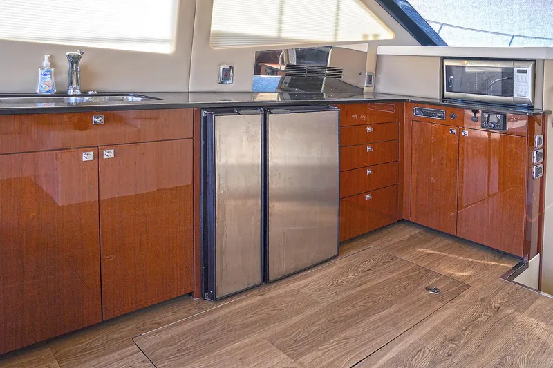 Slide: The Image of Luxurious kitchen interior of 2020 Carver C40 yacht with wood cabinetry and stainless steel appliances. - 15