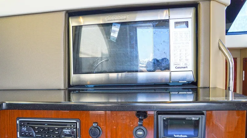 Slide: The Image of Microwave and control panel inside a 2020 Carver C40 yacht kitchen area. - 17