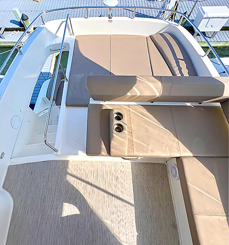 Slide: The Image of 2020 Carver C40 yacht deck with beige seating and cup holders. - 2