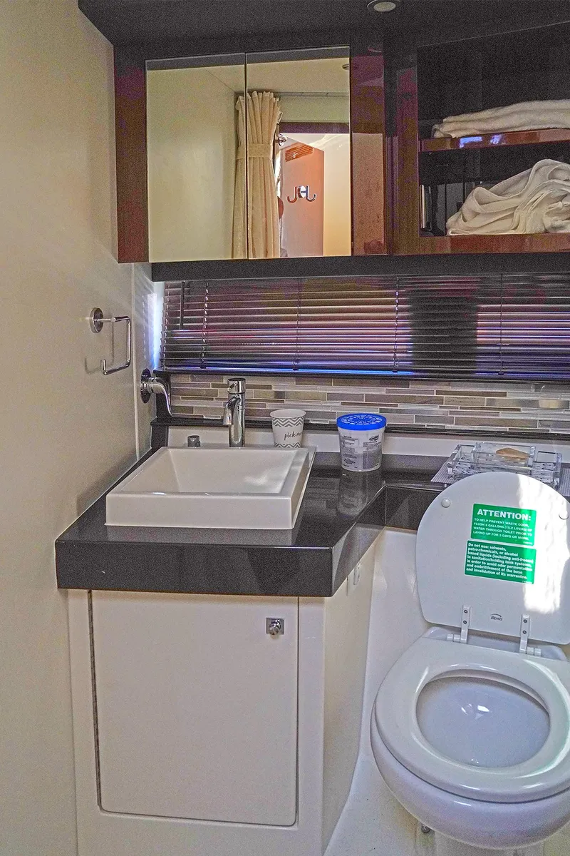 Slide: The Image of Modern bathroom in 2020 Carver C40 yacht with sink, mirror, and toilet. - 26