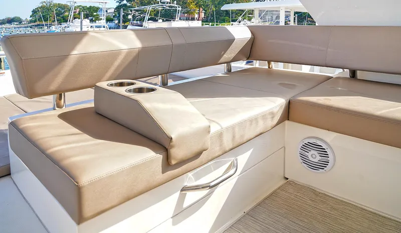 Slide: The Image of Luxurious seating area on 2020 Carver C40 yacht with cup holders and speaker. - 5