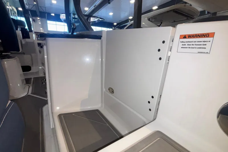 Slide: The Image of 2026 Monterey Elite 27 OB boat interior with safety warning sign. - 10