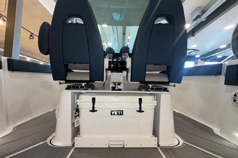 Slide: The Image of 2026 Monterey Elite 27 OB boat interior with Yeti cooler and blue seating. - 15