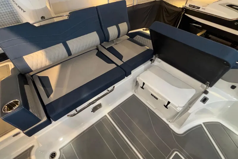 Slide: The Image of 2026 Monterey Elite 27 OB boat interior with blue and gray seating and storage compartment. - 21