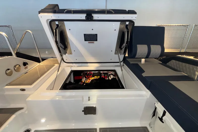 Slide: The Image of 2026 Monterey Elite 27 OB boat storage compartment open, showcasing interior features. - 23