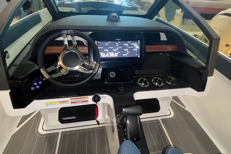 Slide: The Image of 2026 Monterey Elite 27 OB boat dashboard with steering wheel and digital display. - 27