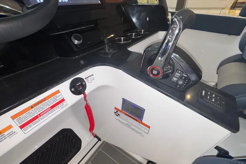 Slide: The Image of 2026 Monterey Elite 27 OB boat cockpit with control panel and safety features. - 29