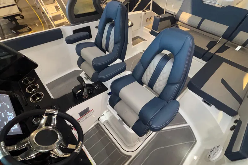 Slide: The Image of Interior of 2026 Monterey Elite 27 OB boat with modern seating and steering wheel. - 30