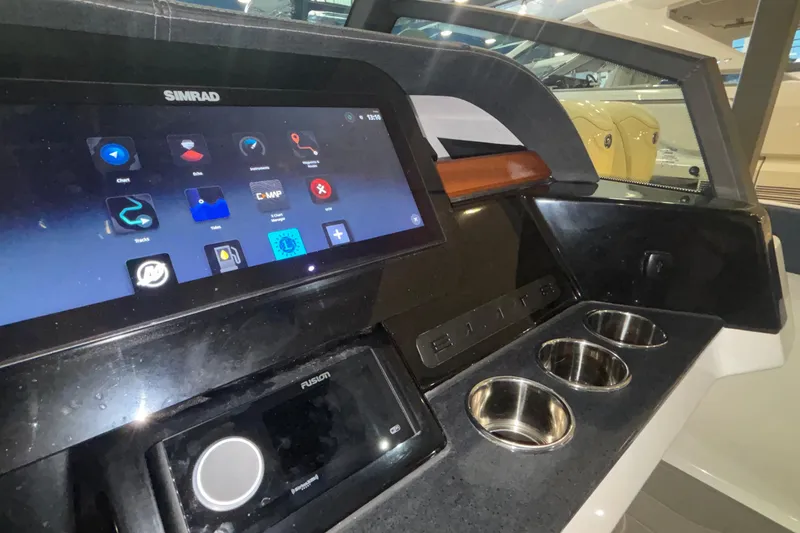 Slide: The Image of Dashboard of 2026 Monterey Elite 27 OB boat with Simrad display and cup holders. - 31