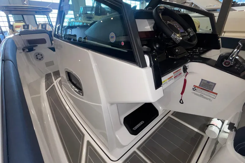 Slide: The Image of 2026 Monterey Elite 27 OB boat interior with steering wheel and control panel. - 32