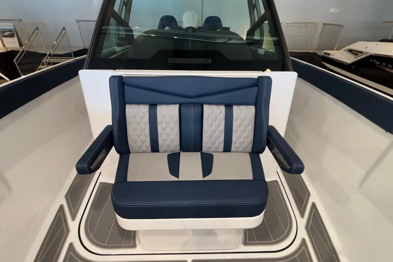 Slide: The Image of 2026 Monterey Elite 27 OB boat interior with blue and gray cushioned seating. - 35