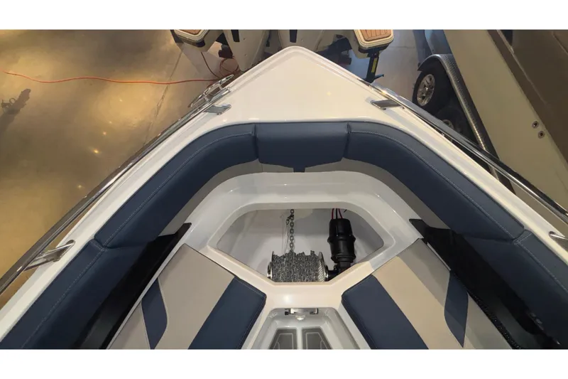 Slide: The Image of 2026 Monterey Elite 27 OB boat interior with blue seating and anchor storage. - 39