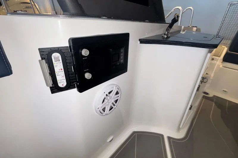 Slide: The Image of 2026 Monterey Elite 27 OB boat interior with control panel and speaker. - 4