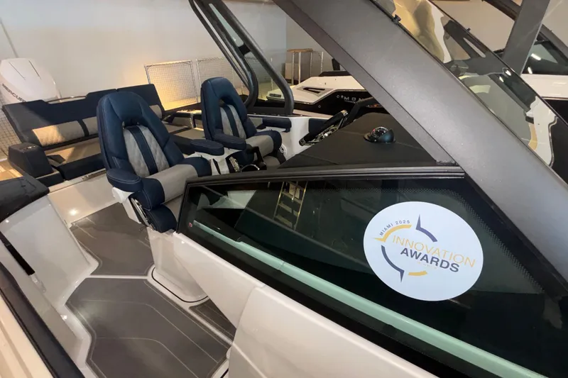 Slide: The Image of 2026 Monterey Elite 27 OB boat interior with award sticker, featuring luxurious seating. - 44