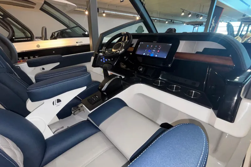 Slide: The Image of Interior of 2026 Monterey Elite 27 OB boat with modern dashboard and seating. - 48