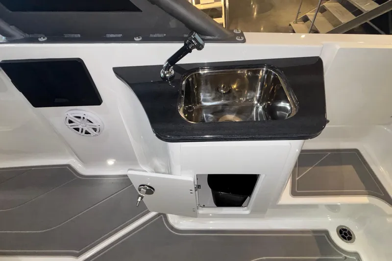 Slide: The Image of 2026 Monterey Elite 27 OB boat interior with sink and storage compartment. - 50
