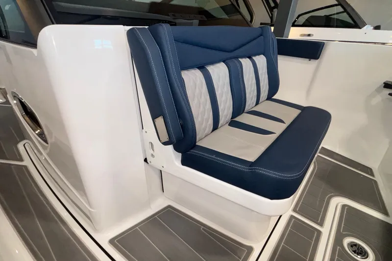 Slide: The Image of 2026 Monterey Elite 27 OB boat interior with blue and gray cushioned seating. - 51