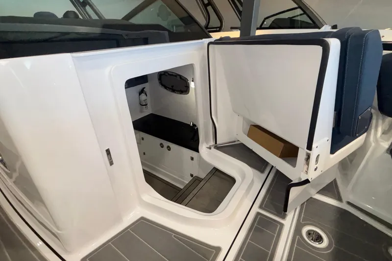 Slide: The Image of Interior view of 2026 Monterey Elite 27 OB boat, featuring a compact cabin space. - 52