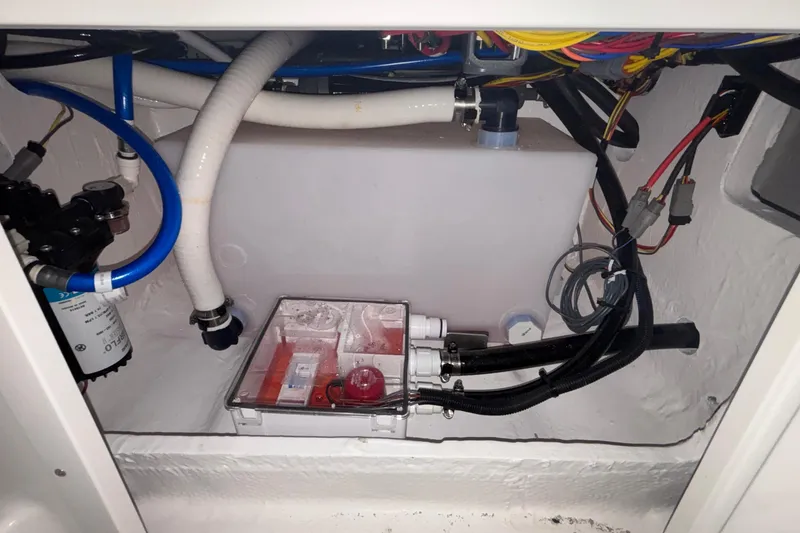 Slide: The Image of 2026 Monterey Elite 27 OB boat engine compartment with wiring and plumbing components. - 59