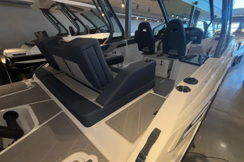 Slide: The Image of 2026 Monterey Elite 27 OB boat interior with modern seating and sleek design. - 6
