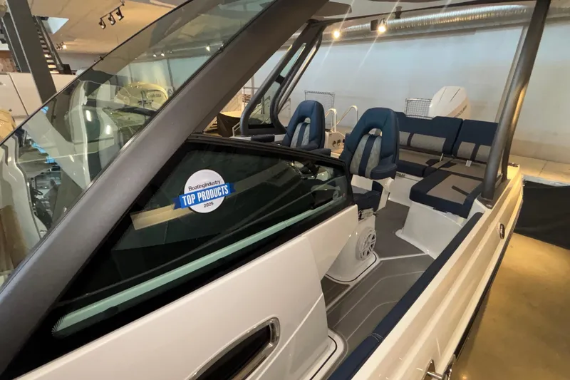 Slide: The Image of 2026 Monterey Elite 27 OB boat interior with award sticker, showcasing modern seating and design. - 65