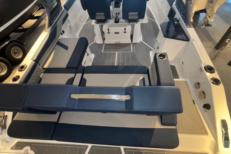 Slide: The Image of 2026 Monterey Elite 27 OB boat interior with blue seating and modern design. - 8