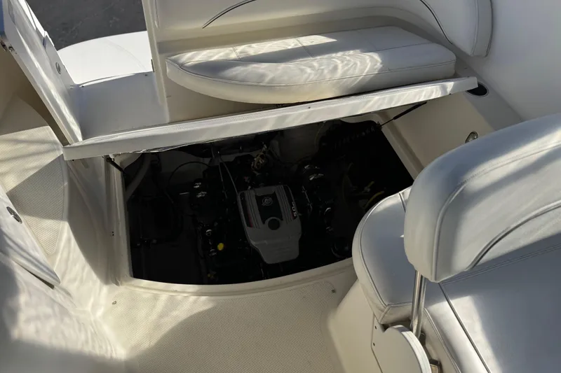 Slide: The Image of 2009 Bayliner 265 SB boat engine compartment with open seating area. - 13