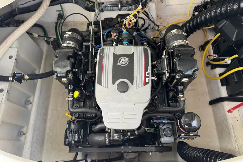Slide: The Image of Engine compartment of a 2009 Bayliner 265 SB boat, featuring a 5.0 MPI engine. - 14