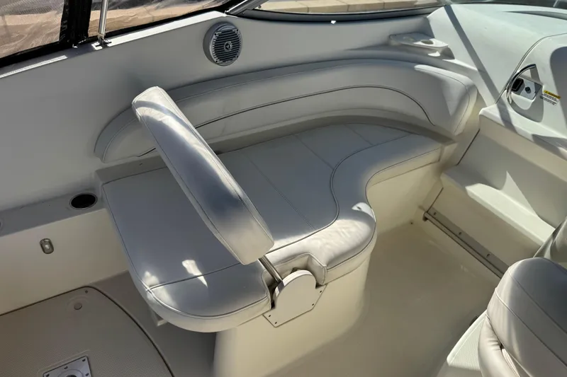 Slide: The Image of 2009 Bayliner 265 SB boat interior with white seating and cup holder. - 17