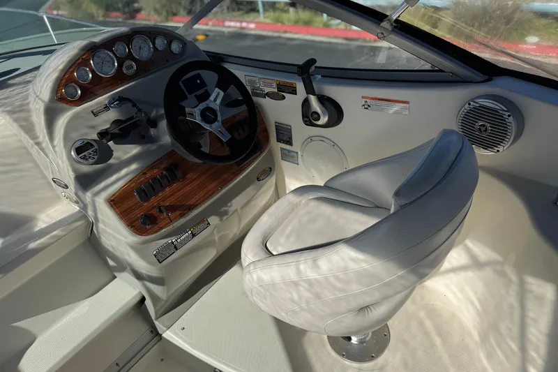 Slide: The Image of 2009 Bayliner 265 SB boat cockpit with steering wheel and control panel. - 19