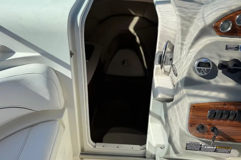 Slide: The Image of 2009 Bayliner 265 SB cabin entrance with control panel and seating. - 22