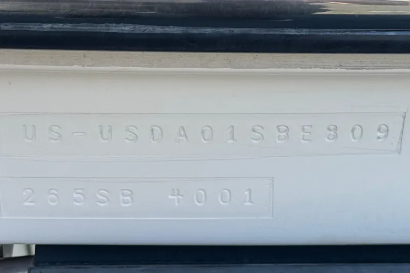 Slide: The Image of 2009 Bayliner 265 SB hull identification number and model details embossed on the boat. - 32