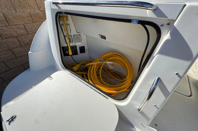 Slide: The Image of Storage compartment of 2009 Bayliner 265 SB boat with yellow power cable. - 7