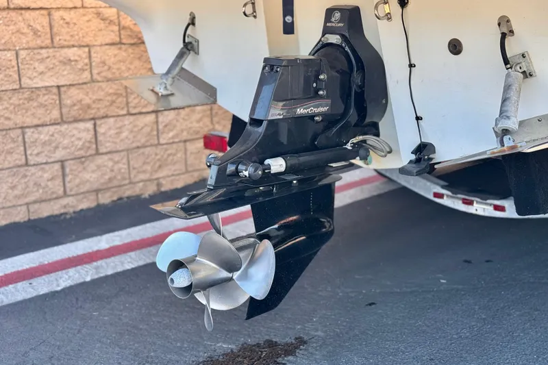 Slide: The Image of 2009 Bayliner 265 SB boat with MerCruiser outdrive and propeller, parked on a trailer. - 8