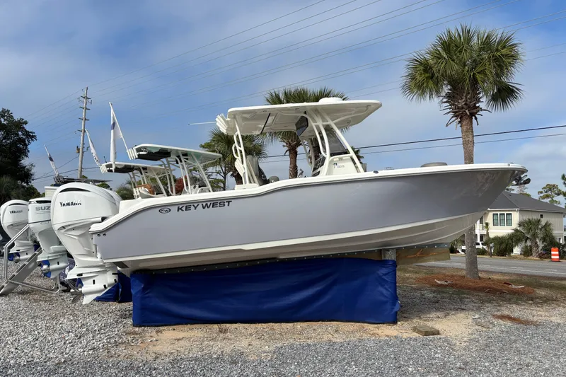 The Image of 2026 Key West 263 FS boat displayed outdoors with palm trees in the background. - 0