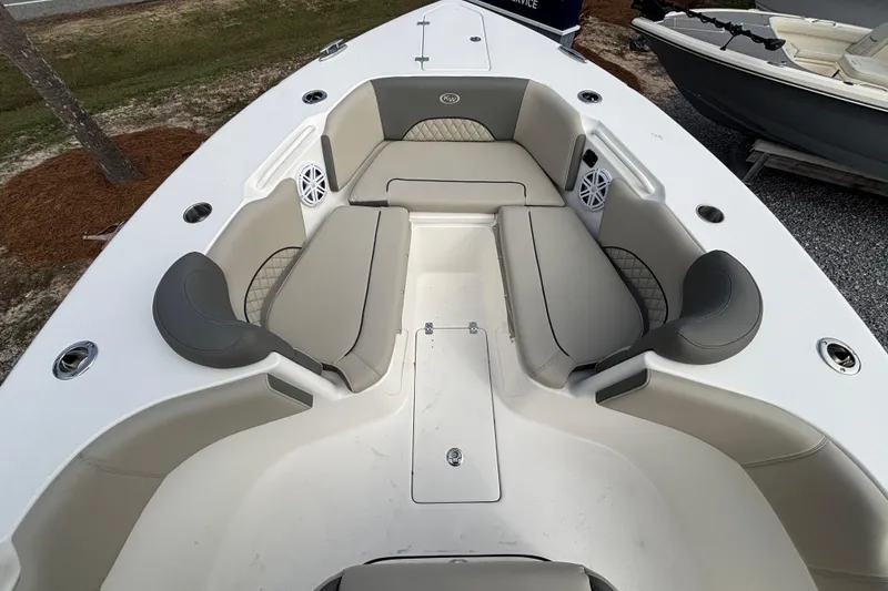 Slide: The Image of 2026 Key West 263 FS boat interior with cushioned seating and built-in speakers. - 10