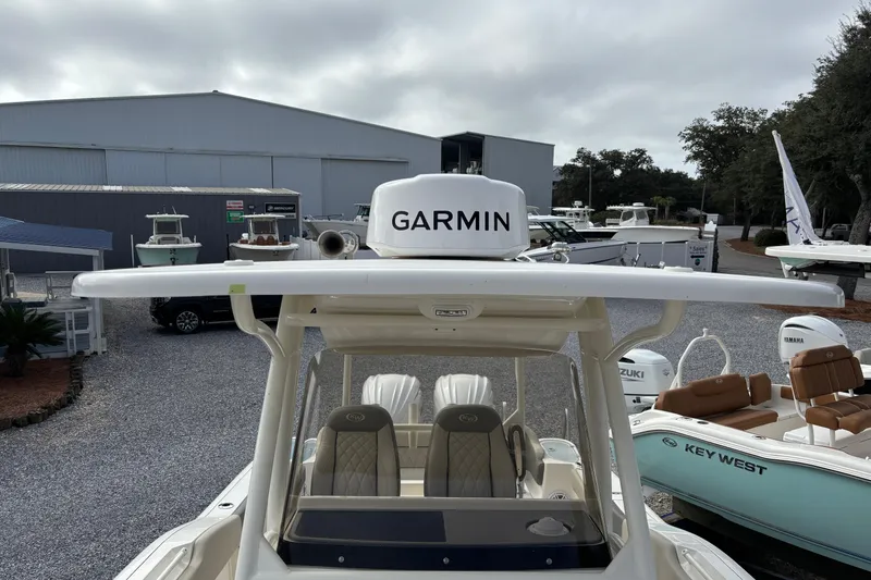 Slide: The Image of 2026 Key West 263 FS boat with Garmin equipment, displayed at a dealership. - 12
