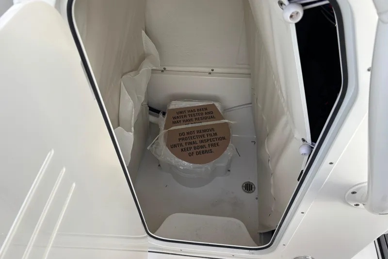Slide: The Image of Interior of 2026 Key West 263 FS boat with protective film on toilet. - 13