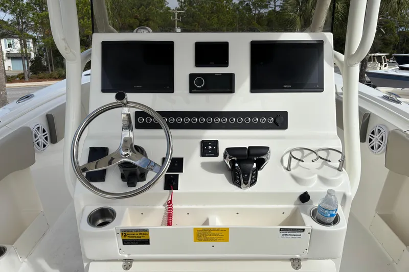 Slide: The Image of 2026 Key West 263 FS boat dashboard with steering wheel, dual screens, and controls. - 15