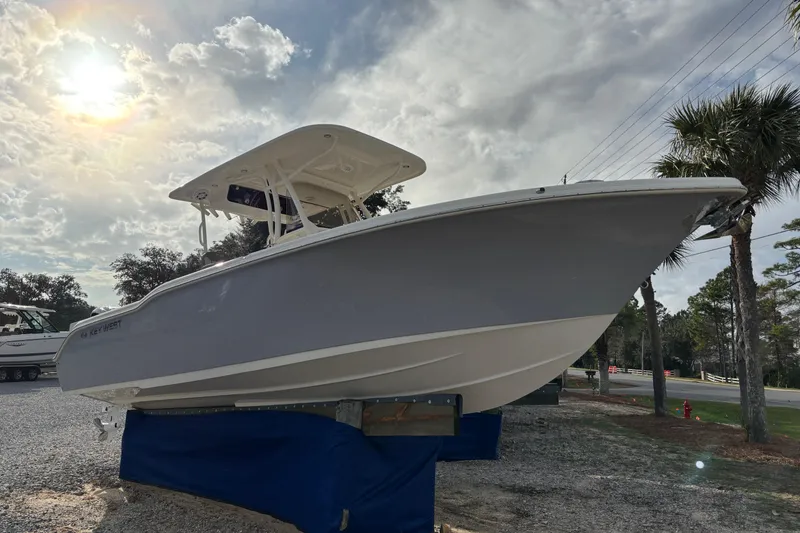 Slide: The Image of 2026 Key West 263 FS boat displayed outdoors under a cloudy sky. - 2