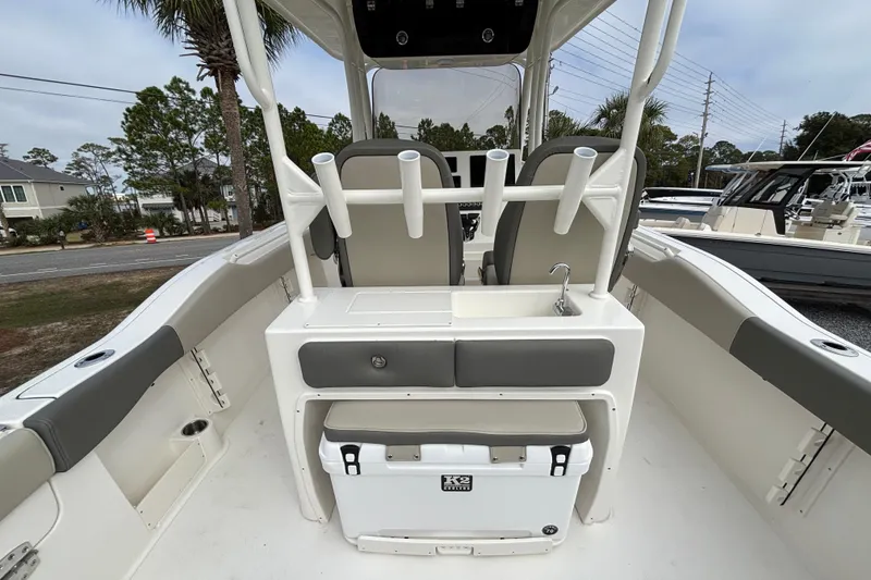 Slide: The Image of 2026 Key West 263 FS boat interior with seating, rod holders, and a sink. - 20