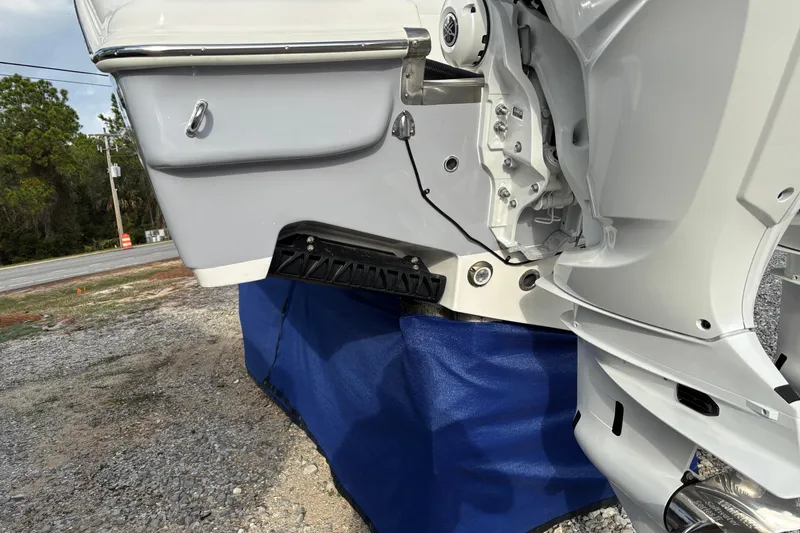 Slide: The Image of 2026 Key West 263 FS boat engine detail on display, resting on a blue cover. - 8