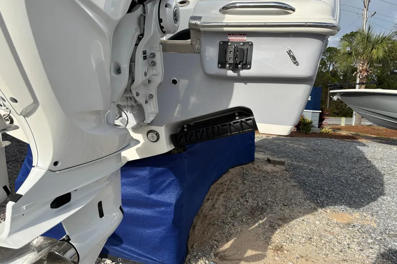 Slide: The Image of 2026 Key West 263 FS boat engine detail on display, resting on blue support. - 9