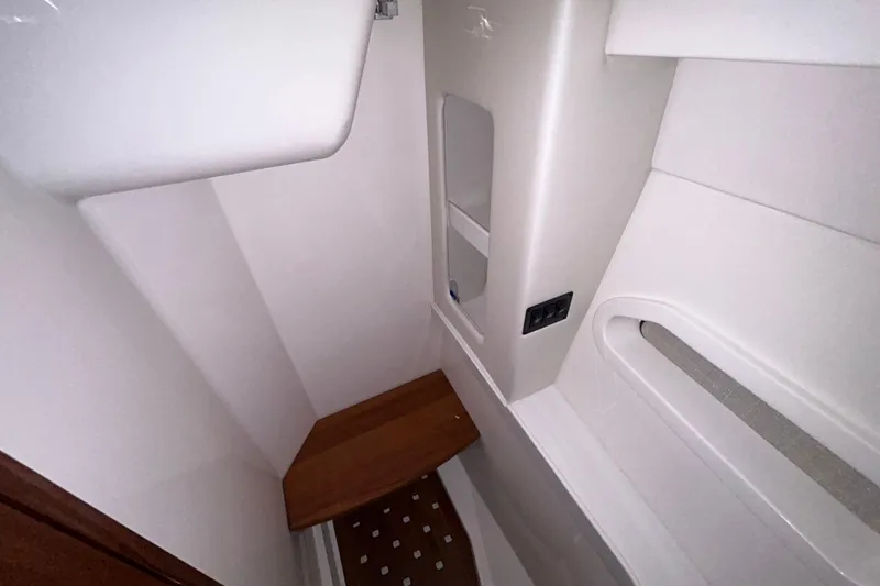 Slide: The Image of 2023 Regal 38 FXO boat interior with modern bathroom design and wooden accents. - 102